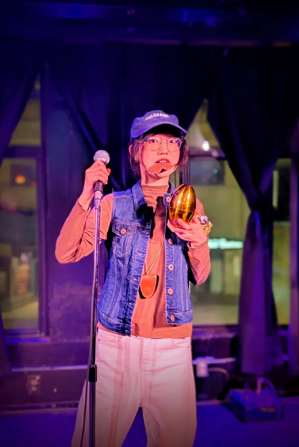 Comedian on stage holding a microphone