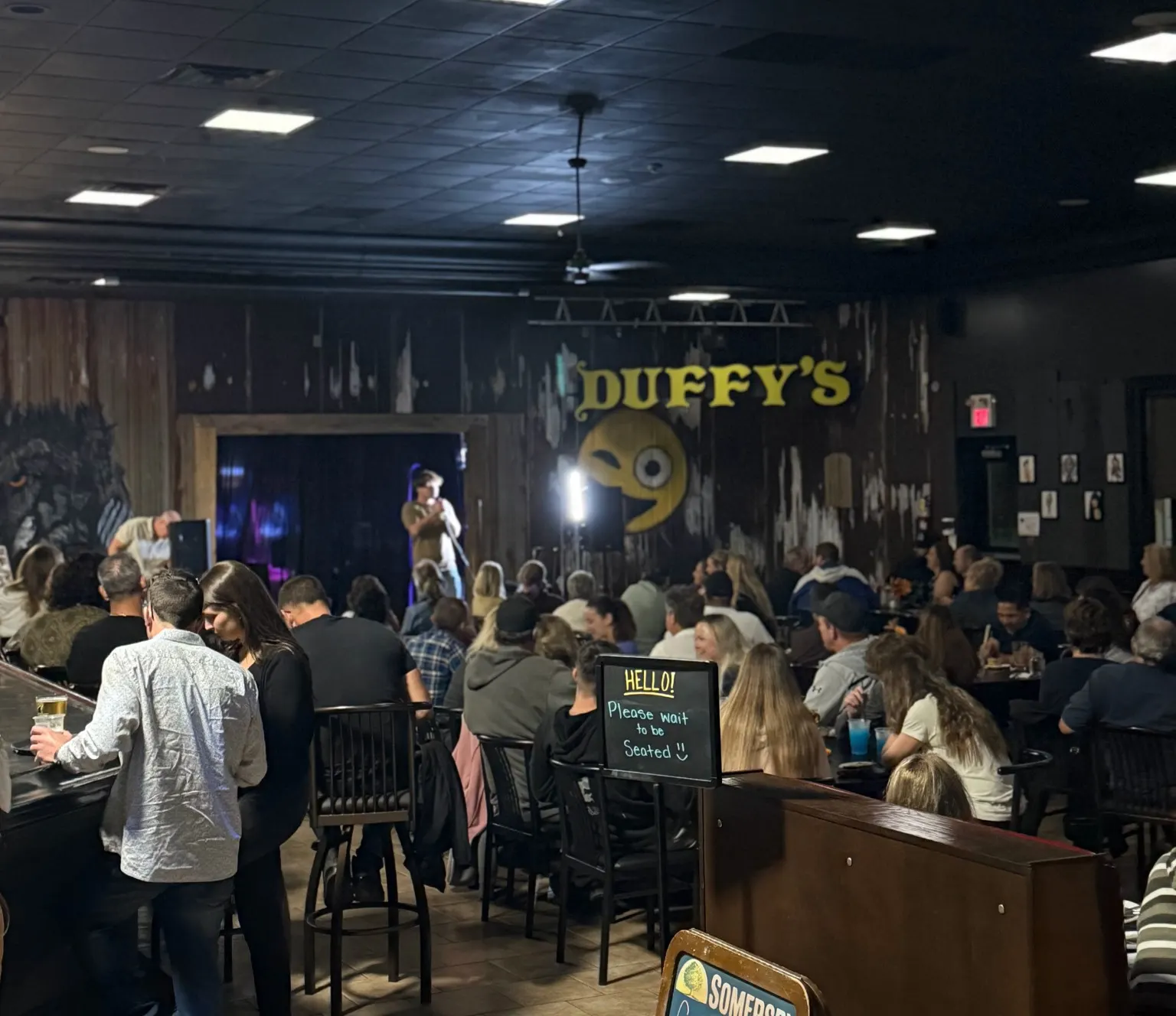 Audience watching a live comedy show at Duffy's